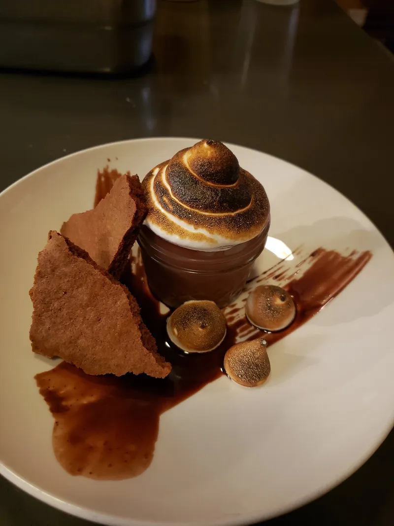 Plated chocolate dessert with torched meringue